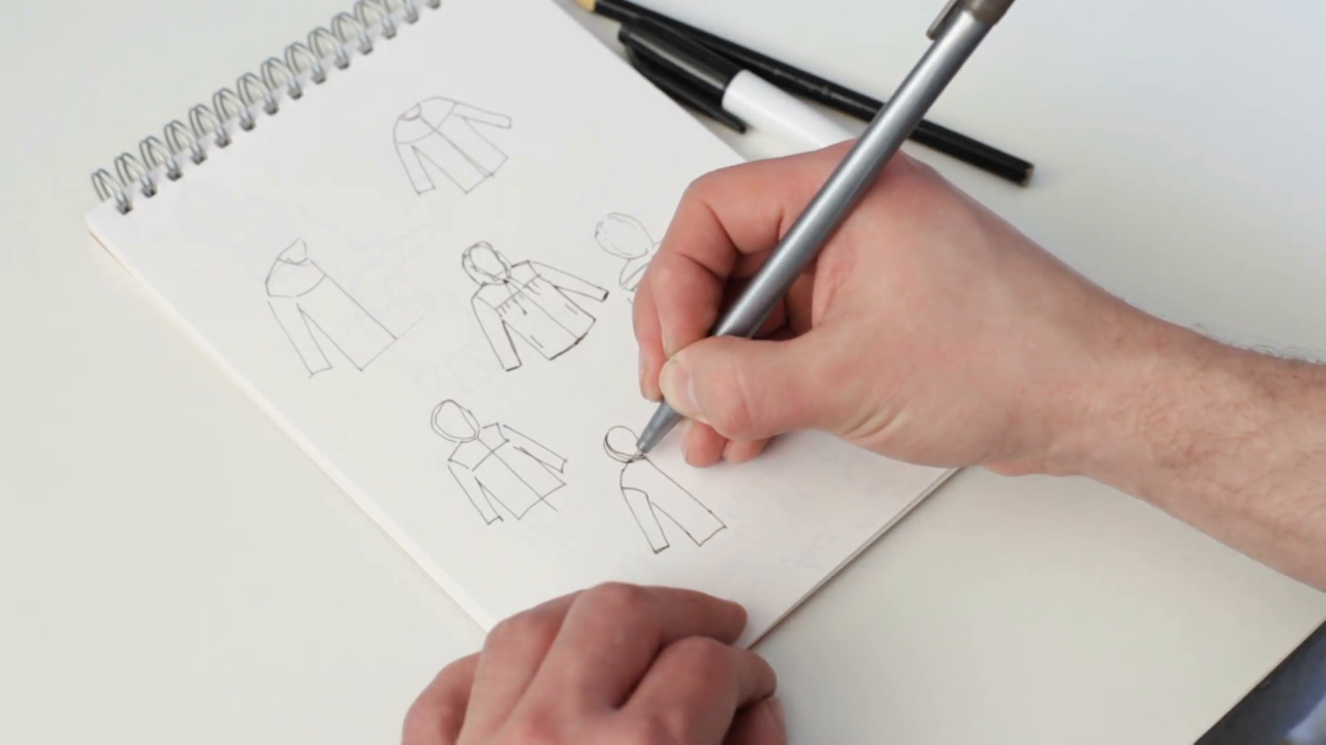1920x1080 man's hand holding a pen fashion designer draws a sketch - Designer Drawing