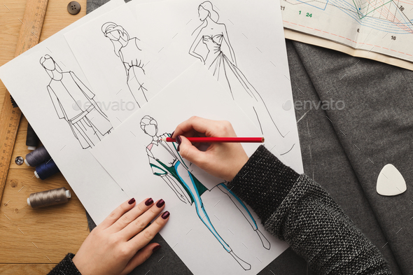 590x393 top view on woman designer drawing clothes sketches stock photo - Designer Drawing