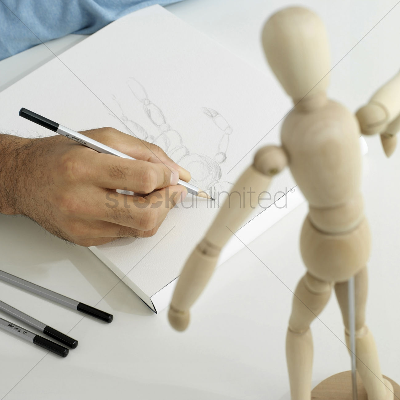 1300x1300 Man's Hand Drawing Wooden Dummy Stock Photo - Drawing Dummy