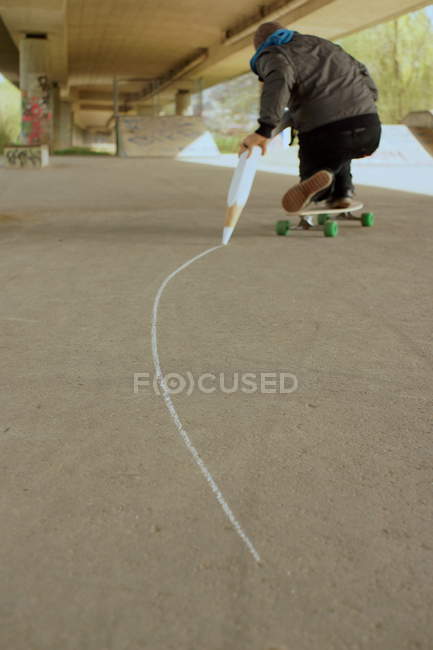 433x650 Man Riding On Longboard And Drawing A Line With Big Chalk Pencil - Longboard Drawing