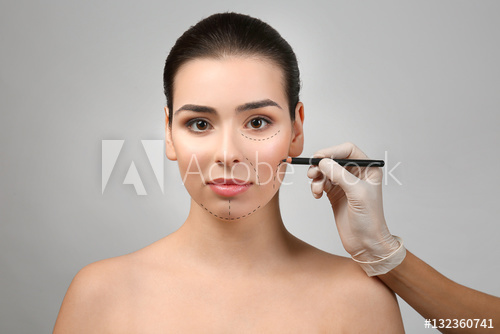 500x334 Surgeon Drawing Marks On Female Face Against Gray Background - Plastic Surgery Drawing