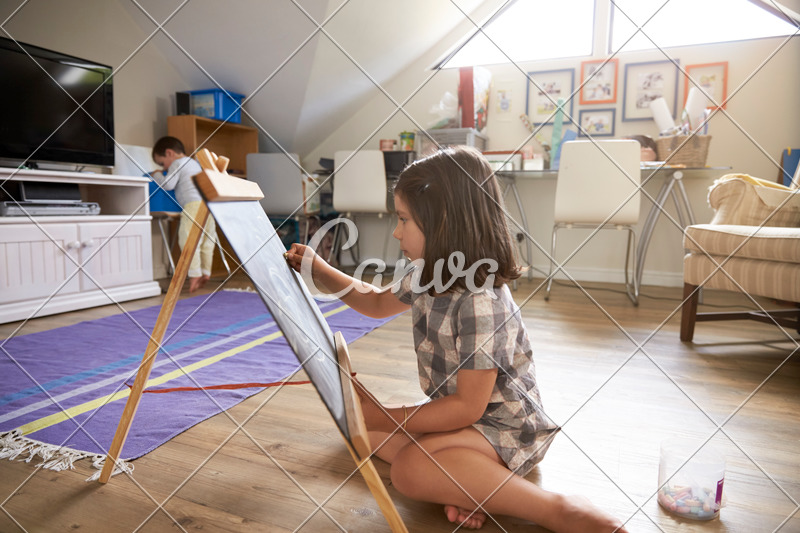 800x533 girl drawing on chalkboard in playroom - Playroom Drawing