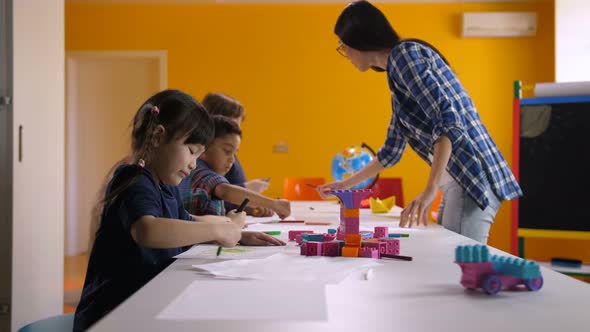 590x332 multicultural children drawing in kindergarten - Preschool Children Drawing