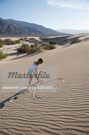299x450 woman drawing a heart in the sand, sand dunes point, death valley - Sand Dunes Drawing