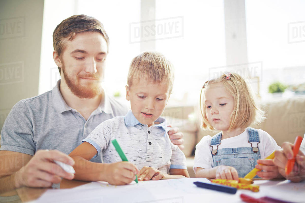 1200x800 two kids and their father drawing with crayons - Two Kids Drawing