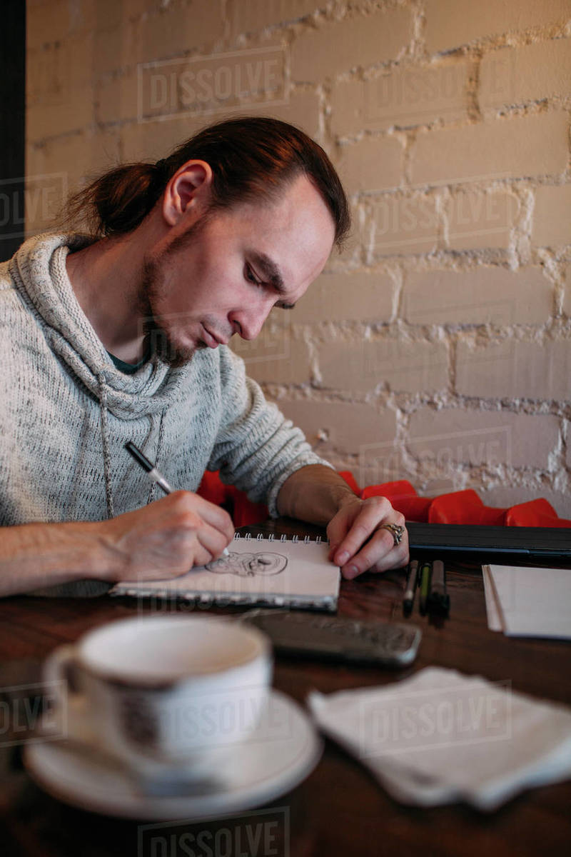 800x1200 Young Man Drawing In Book On Table - Young Man Drawing