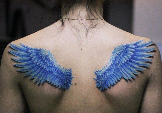 550x385 Wing Tattoos Across The Shoulders And Back Tattoo Articles - Watercolor Angel Wings Tattoo