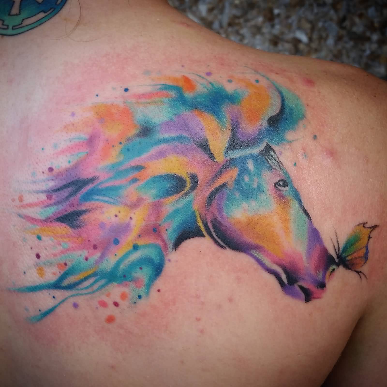 Watercolor unicorn back tattoo