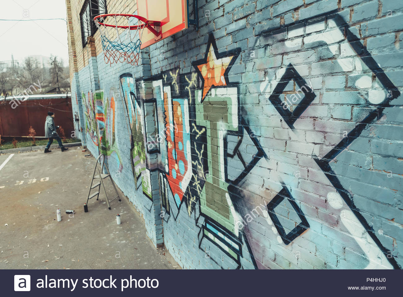 1300x957 Man Painting Colorful Graffiti On Wall With Basketball Hoop Stock - Basketball Hoop Painting