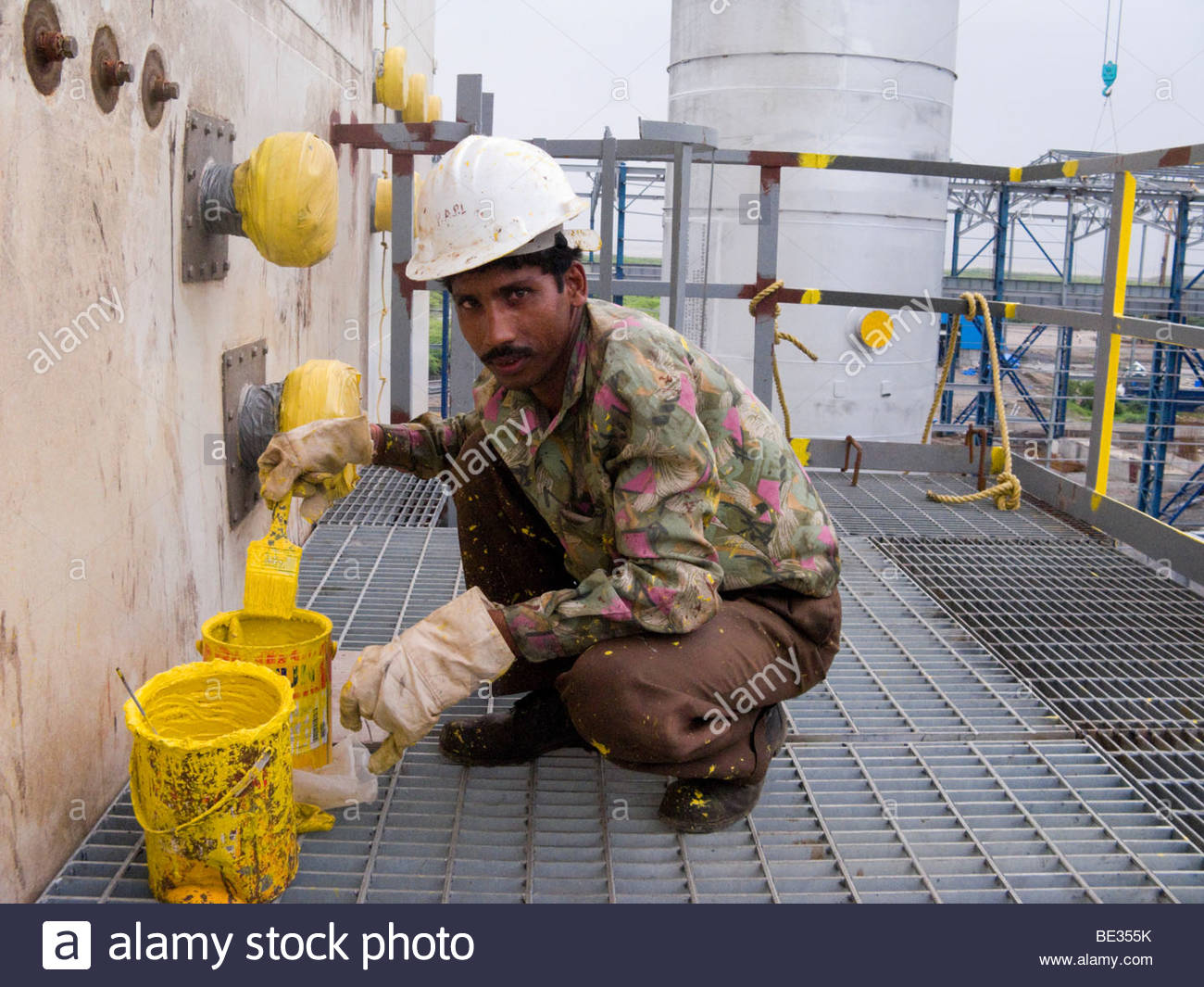 1300x1065 Indian Construction Worker Painting A Wall In An Industrial Plant - Construction Painting