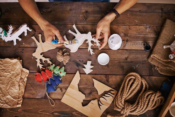 590x394 Craftsman Painting Wooden Deers With White Gouache Stock Photo By - Craftsman Painting