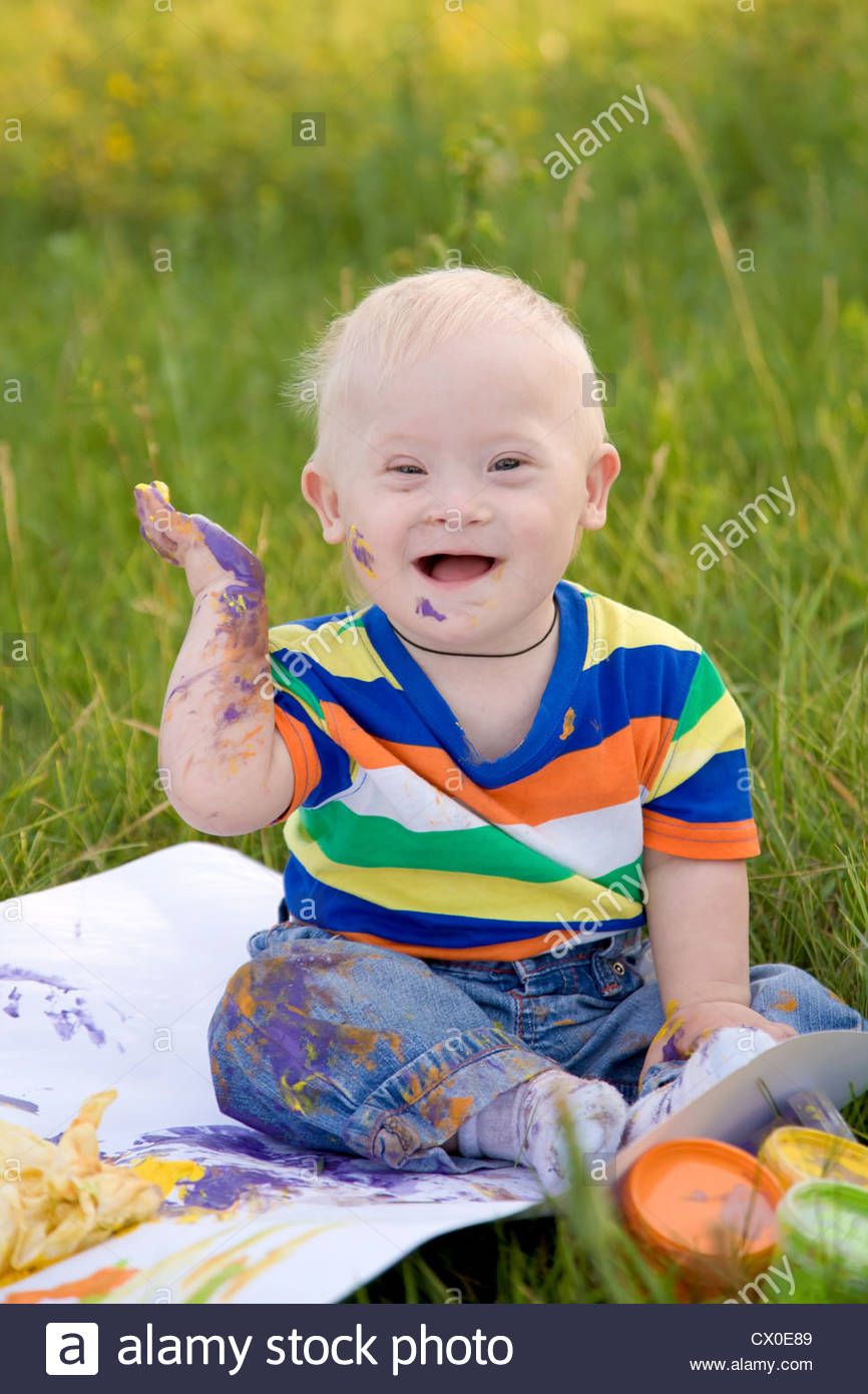 866x1390 Little Baby Boy With Down Syndrome Painting Finger Paints On White - Down Syndrome Painting
