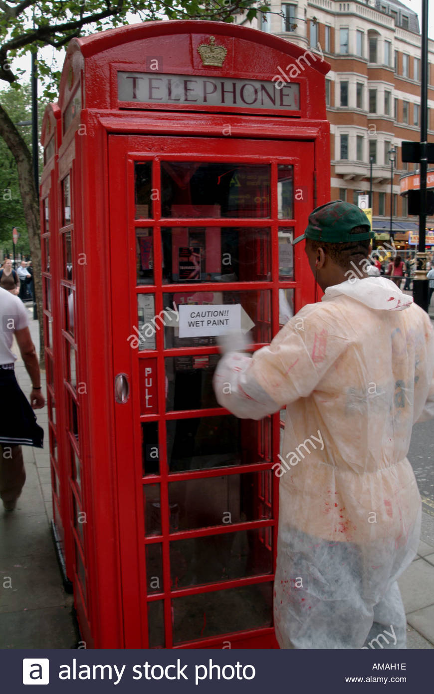 870x1390 Man Painting The Red Telephone Box London G Britain Stock Photo - London Phone Booth Painting