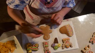 320x180 Woman Takes Man Cookie From Basket Painting It Decorating - Painting Christmas Cookies