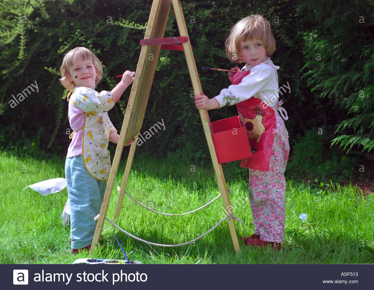 1300x1009 Two Young Children Painting Outside In The Garden Stock Photo - Painting For Young Children