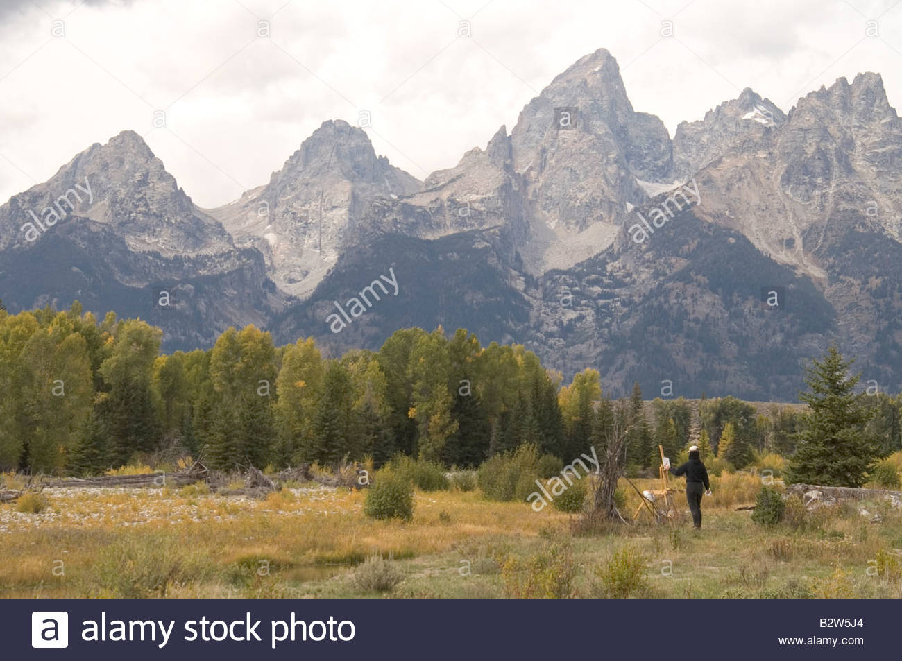 1300x953 Artist Painting And The Grand Tetons Rocky Mountains Stock Photo - The Rocky Mountains Painting