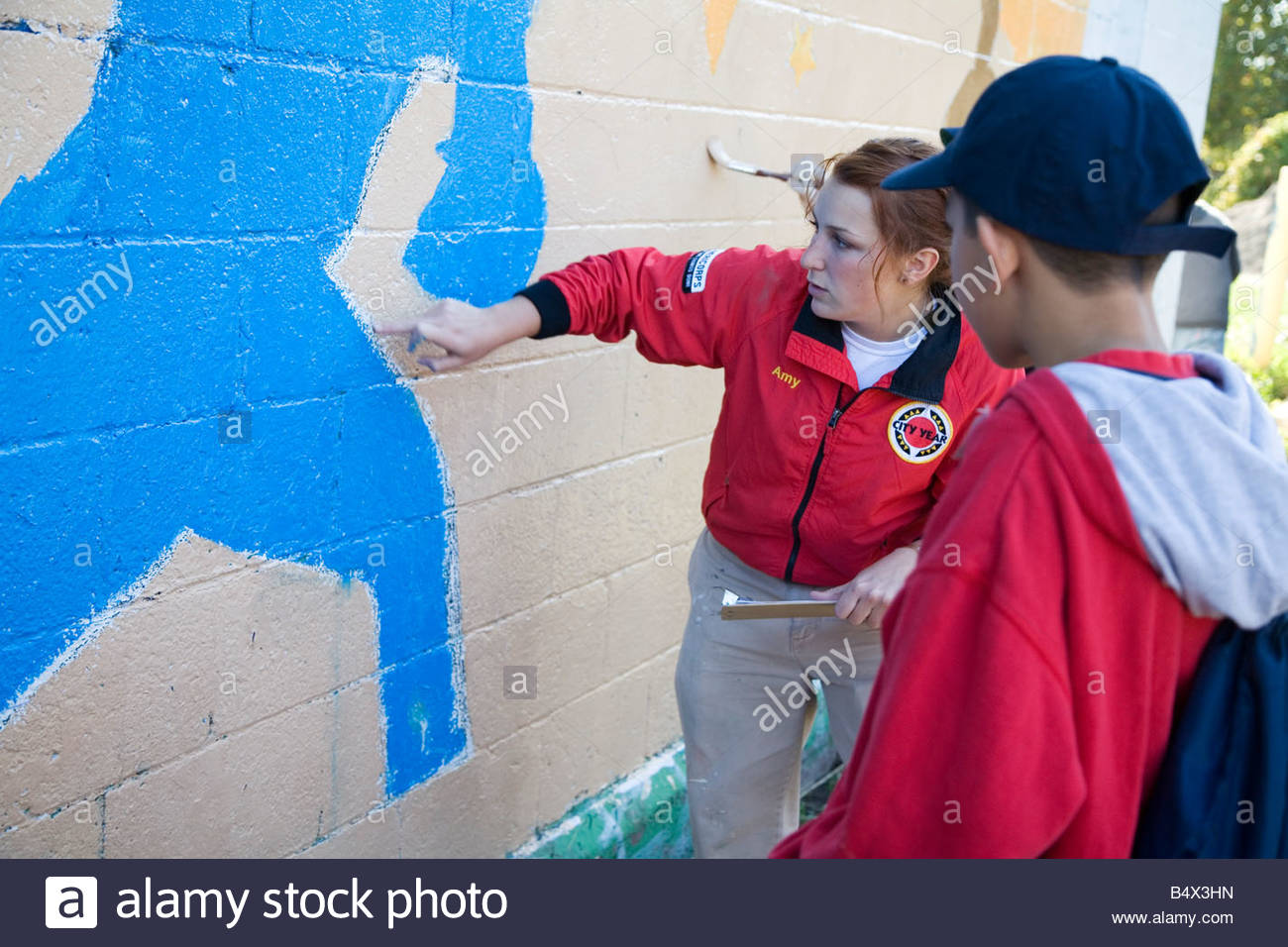 1300x956 City Year Volunteer Works With Youth Painting Mural Stock Photo - Volunteer Painting